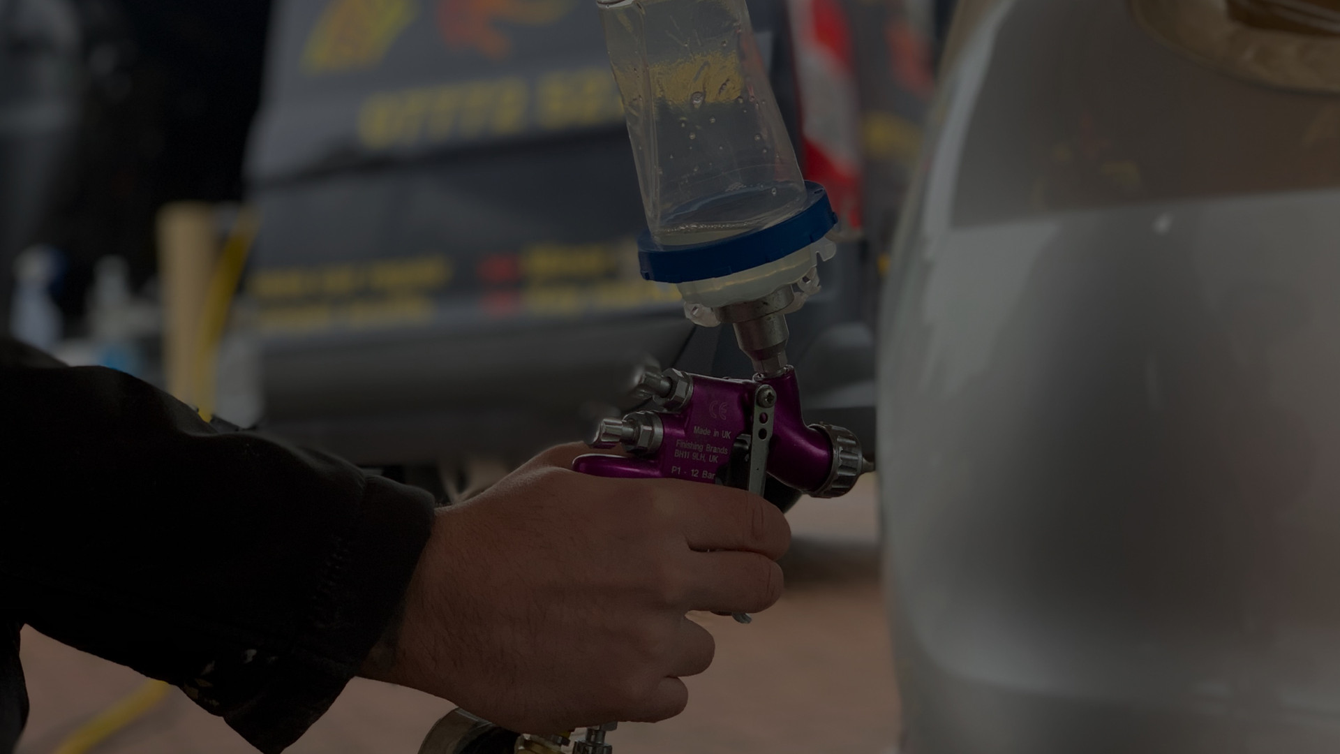 Close-up of spray gun at work